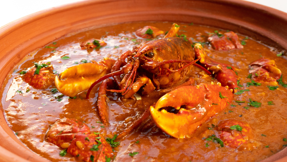 Lobster stew in a clay pot dish. Caldereta de bogavante