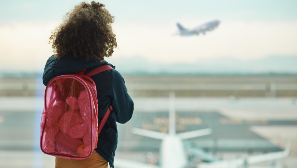 Child with rucksack at airport