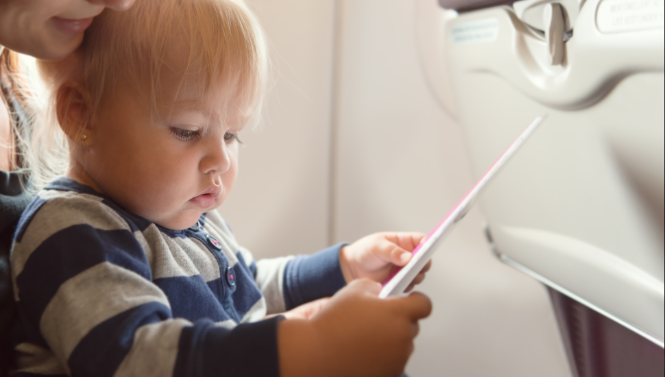 Child holding in flight safety instructions