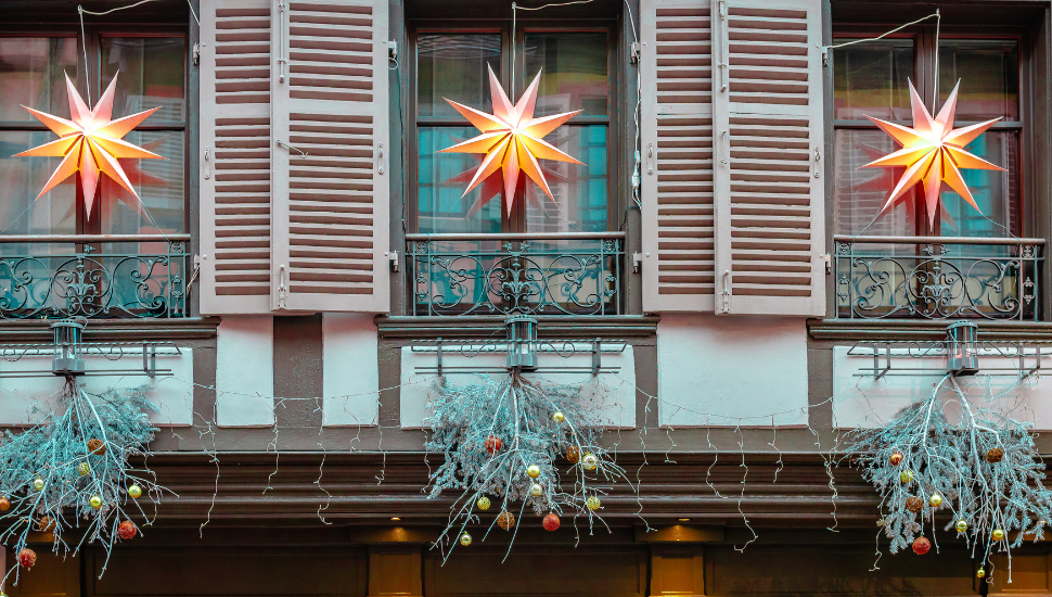 Christmas decorations on windows of building in Ribeauville