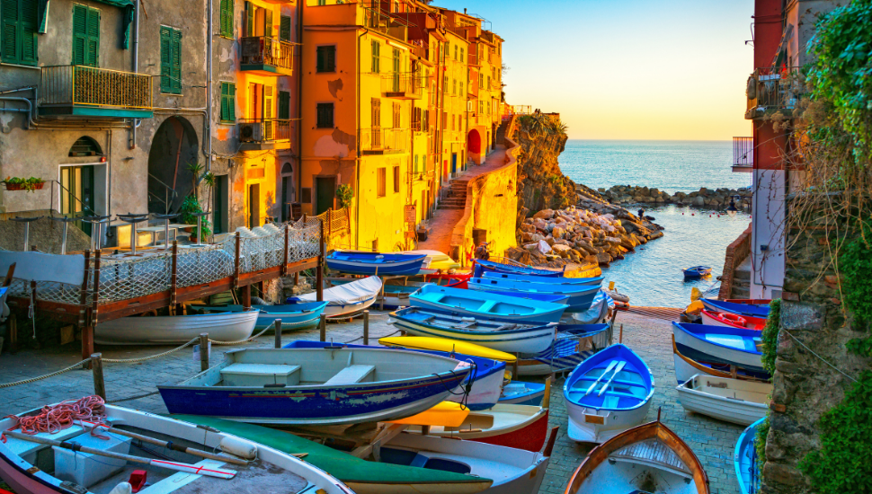 Riomaggiore village street, boats and sea. Cinque Terre, Italy.