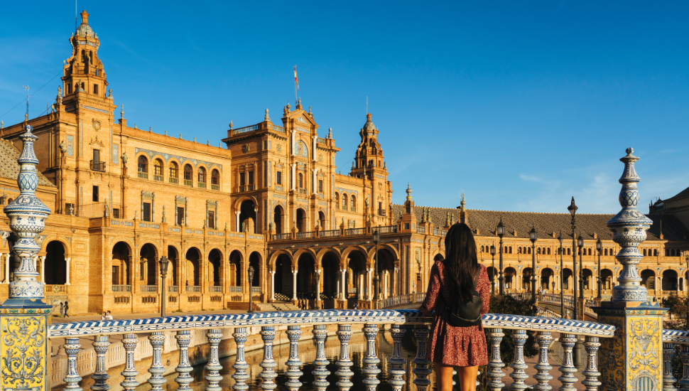 Woman tourist looking views in the bridge of Spain Square in Seville, Spain