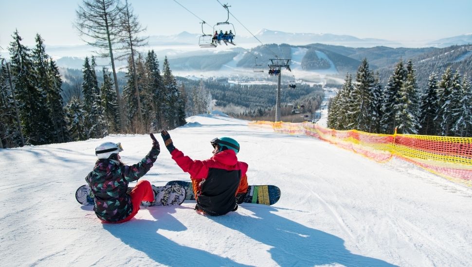 Snowboarders at top of ski slope